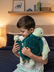 Mini & Me Weighted Plush Turtle hugged by child
