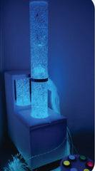 A blue bubble tube on a mobile sofa podium, complete with optic fiber lights and an interactive switchbox.
