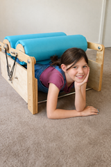 A young girl using the calming roller in the double-size version.