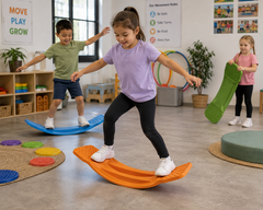 Penguin Rocker balance board being used by children in an inclusive early learning movement room to develop balance, coordination and gross motor skills.