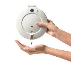 This is an image of the Pivotell Careousel Automatic Pill Dispenser. It is an image of white electronic device dispensing small red capsules onto a person's palm against a white background