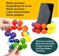 Mobile phone with a Rainbow Art Balls Fidget wrapped around it, and a pair of hands holding an expanded Rainbow Art Balls Fidget