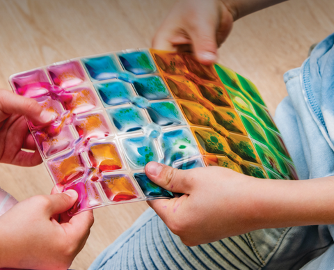 Children playing with Rainbow Squares Sensory Pads set of colourful visual sensory fidget pads for calming play, visual tracking, tactile exploration and sensory regulation