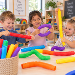 Children enjoying colourful Rainbow Pull Pipes for sensory play and fine motor development in a preschool classroom.