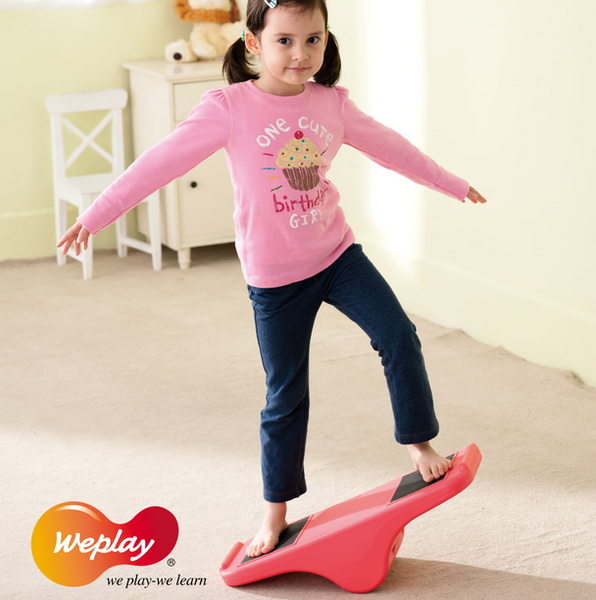 Child using Weplay Rocking See Saw to develop balance, coordination and gross motor skills