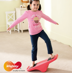Child using Weplay Rocking See Saw to develop balance, coordination and gross motor skills