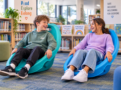Two children using Rocking Floor Chairs in green and blue