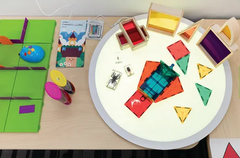 Round Colour Changing Light Panel 60cm turned off with cut out shapes spread over it