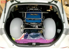 This is an image of the Sandcruiser® All Terrain Chair – Beach Wheelchair folded down and fitted into the back of a car!