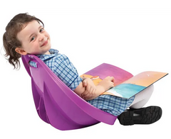 Young child looking back sitting in scoop rocker chair for movement and focus in classroom setting