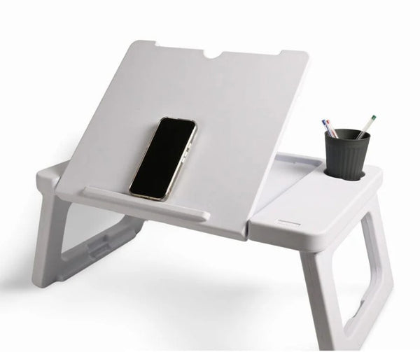 Foldable laptop desk with a phone and cup on a white background