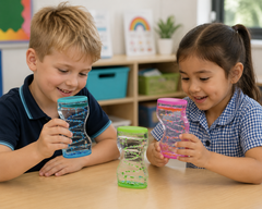 Children exploring colourful liquid sensory timers in a classroom.