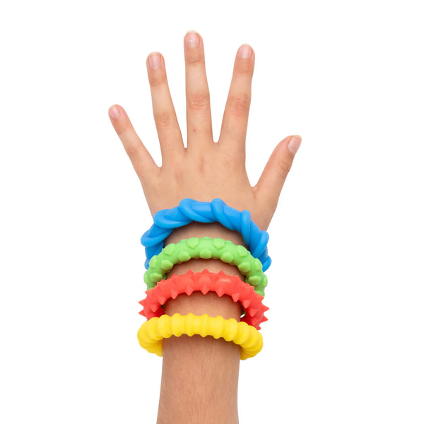 Hand wearing 4 colorful silicone bands.