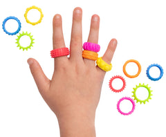 Hand wearing colorful rings with different textures.