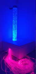 150C LED bubble tube on sofa podium with fibre optic tails streaming out from inside the podium lit up with pink light