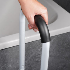 Hand holding a handle of Step Stool near bath.
