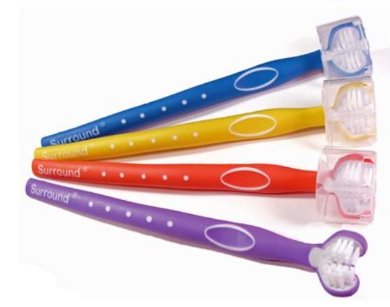 Four Surround Toothbrushes with triple brush design. Handle colours are blue, yellow, orange, and purple