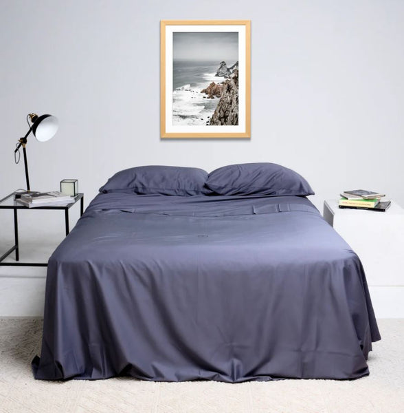 This is an image of a bed made with The Lad Collective™ 2.0 Original Bedding Set and Fitted Sheets - Easy to Make Bed Linen. This colour is dark grey and is called Tasman.