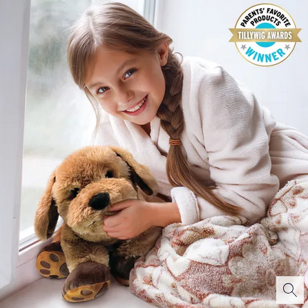 Young girl holding Theo the Therapy Dog weighted lap companion with soft plush fur and weighted body