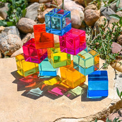Translucent gem cubes arranged outdoors.