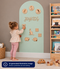 A young child stands at a duck egg coloured Magnetic Chalk Wall Archway using wooden animal magnets and decorative learning pieces to explore matching, identification and interactive play.