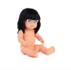 Toddler baby doll with glasses sitting up naked