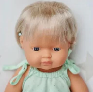 Toddler baby girl doll with hearing implant close up of head and bust