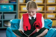 Training2s Weighted Shoulder Pad in red Patrick the Dog design on young girl's shoulders