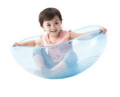 Child using WePlay Rocking Bowl for rocking, balance and gross motor movement play