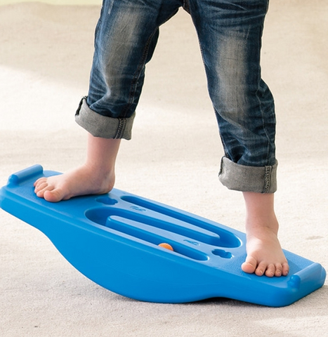 Young child using the WePlay Seesaw Balance & Ball Run for children's balance, gross motor coordination and visual tracking activities