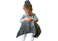This is an image of a Child sitting on the ground with a weighted lap pad over their knees. It shows the grey side of the lap pad.