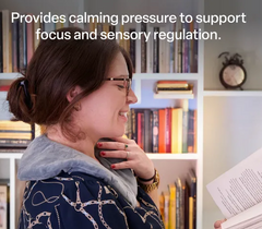 Woman using the Weighted Shoulder Wrap 1.35kg as she reads a book.