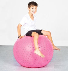 Child sitting on a pink 65cm Spike Swiss Ball during a supervised balance and movement activity.