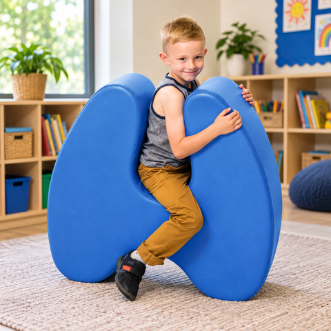 A child sits in a blue squeezie seat that supports both his back and front.