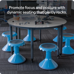 Table with blue rocking stools in a classroom setting