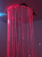 This is an image of a sensory fibre optic Curtain ring + Adaptor hanging from a ceiling. The lights are red.