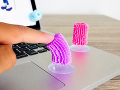 Close-up of person using colourful Sensory Flick Sticks as a quiet desk fidget tool