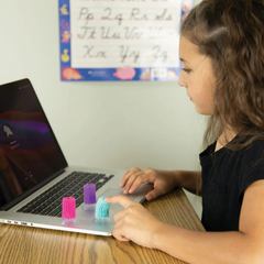 Child using a tactile Sensory Flick Stick during a classroom learning activity