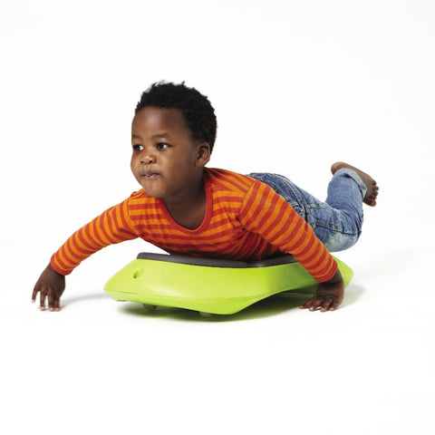 Child using green Floor Surfer for gross motor play