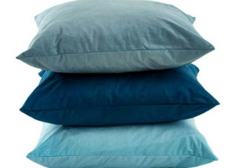 This is an image of 3 blue cushions stacked up.