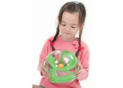 This is an image a child using the Tai-Chi 20 cm ball  for sensory overload. It is a clear outer ball with a green inner maze and an orange ball.