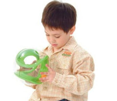 This is an image a child using the Tai-Chi 20 cm ball  for sensory overload. It is a clear outer ball with a green inner maze and an orange ball.