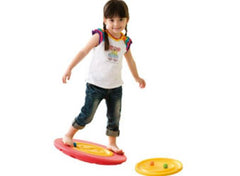 This is an image of a child using the Tai-Chi Balance and Rehab Board - small with interchangeable discs.