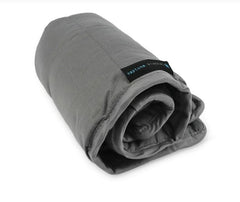 This is an image of the Therapeutic Weighted Lap Pad. It is grey and is rolled up.