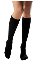 Child's legs wearing black calmcare knee high sensory socks 