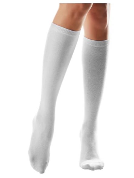 Child's legs wearing white calmcare knee high sensory socks 