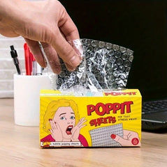 This is an image someone pulling bubble wrap sheets out of a box called Poppit Sheets