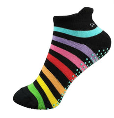 This is an image of Gripperz Socks. They are black with coloured stripes of green, yello, ornange, red, hot pink, purple and light blue with light blue rubber dots on the bottom.