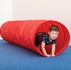 This is an image of a red nylon tunnel. There is a small boy crawling inside.