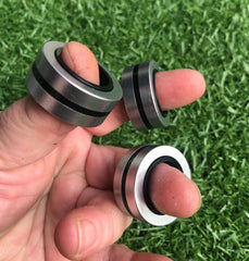 This is an image of someone holding Magnetic Fidget Rings with their fingers spread